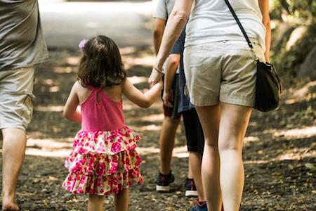 girl-holding-hands-parent